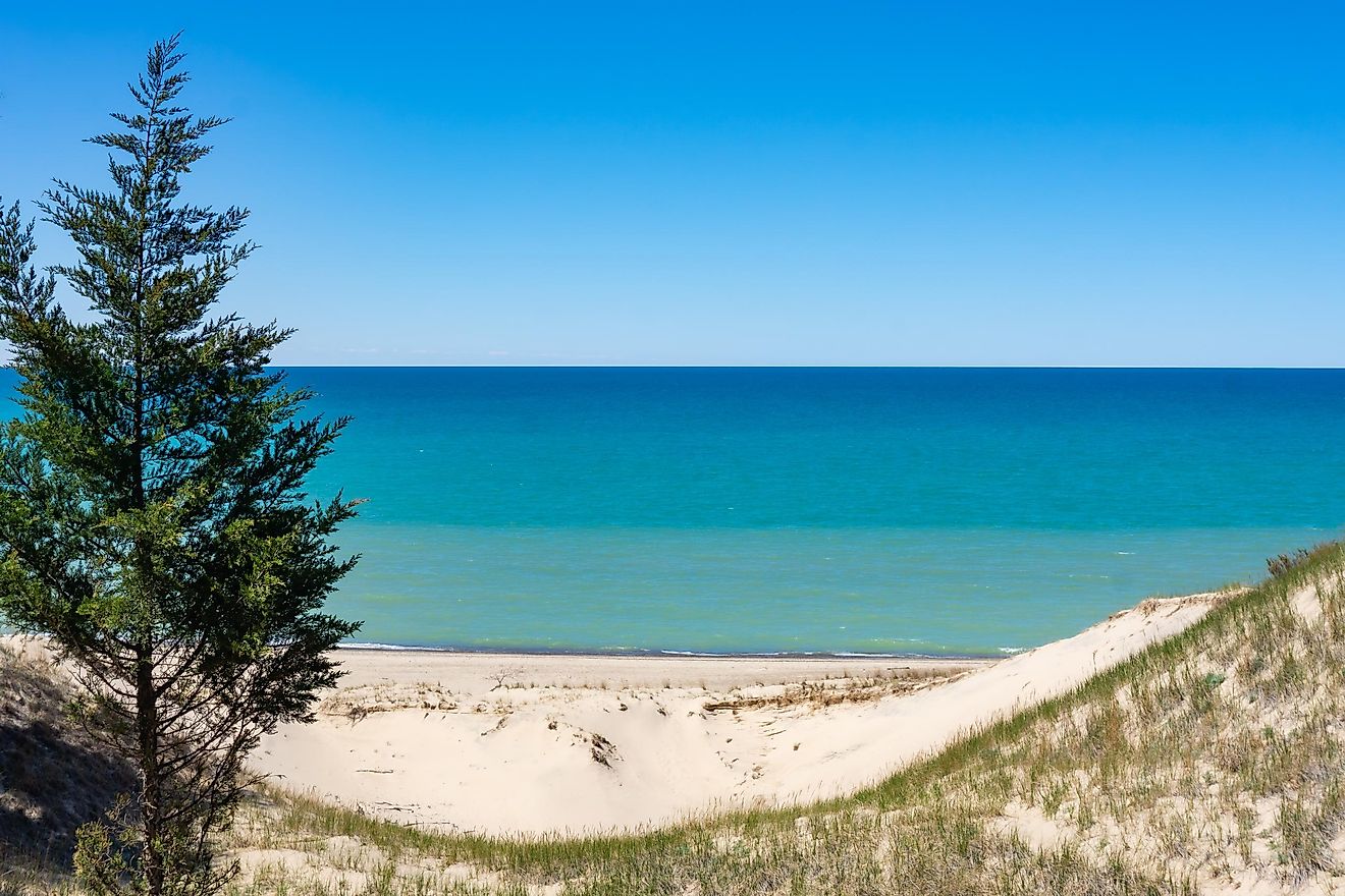 The fresh blue waters of Lake Michigan meet the beaches and wild-grass-strewn dunes along its southeastern shore.