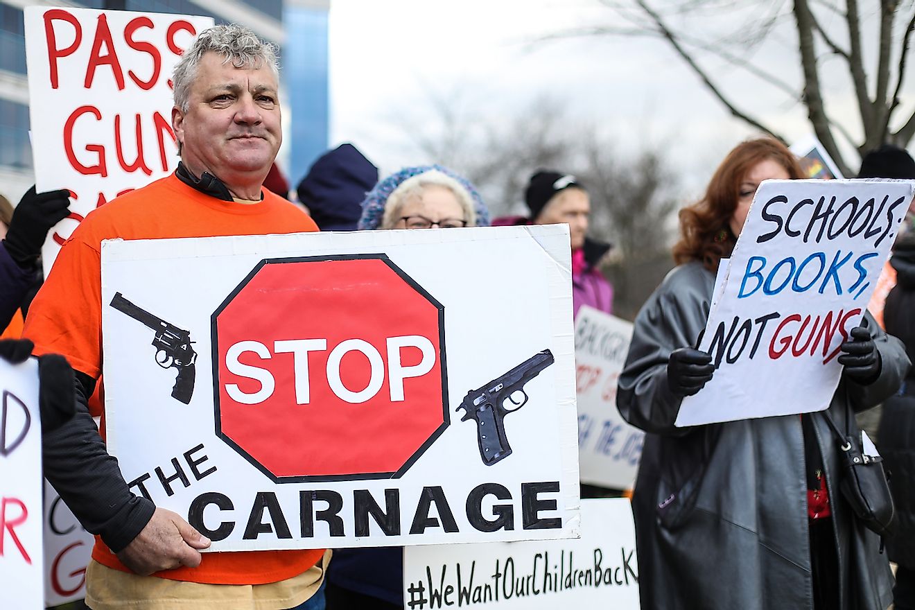 Protesters gather outside of the National Rifle Association headquarters for a vigil in remembrance of the 2012 Sandy Hook Elementary School massacre in Newtown. Image credit:  Nicole Glass Photography/Shutterstock.com