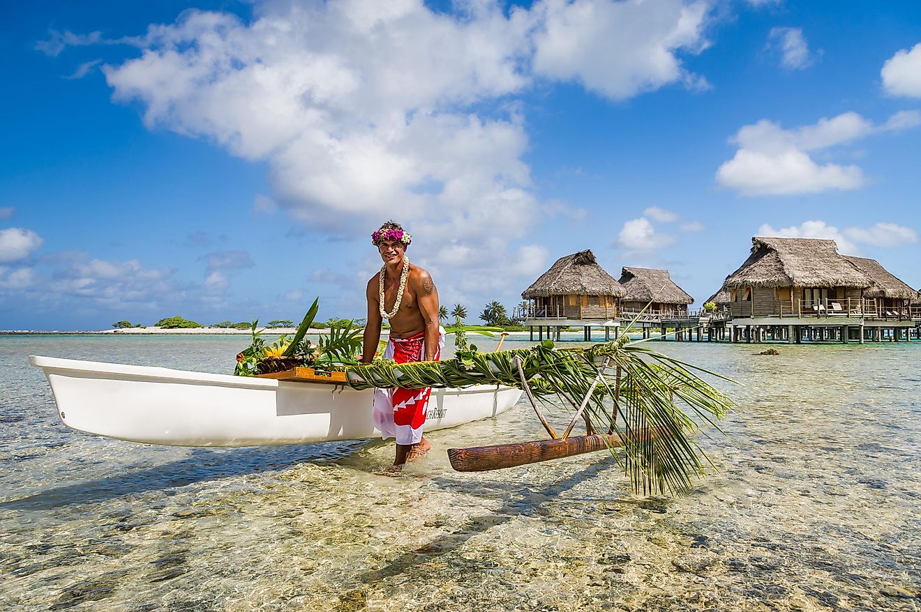 A local man canoeing for food delivery in an island resort in French Polynesia, a part of Polynesia. Image credit: Shen max/Shutterstock.com