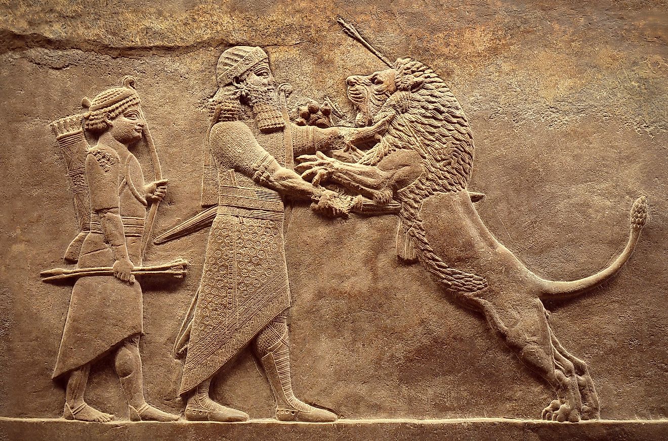 Assyrian wall relief, detail of panorama with royal lion hunt. Old carving from the Middle East history. Remains of culture of Mesopotamia ancient civilization. Image credit: Viacheslav Lopatin/Shutterstock.com
