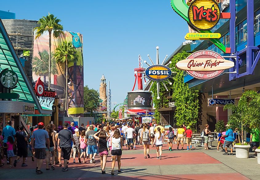 A crowd of visitors walking towards the entrance of the Universal Orlando Resort theme parks