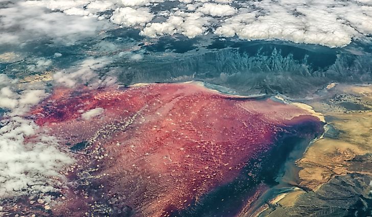 An aerial view of Lake Natron in northern Tanzania, with its characteristic red-pink color and salt crust.
