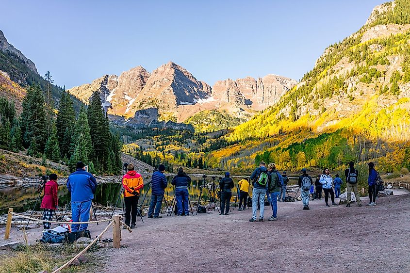 Many people on trail taking pictures of sunrise at Maroon Bells, Colorado