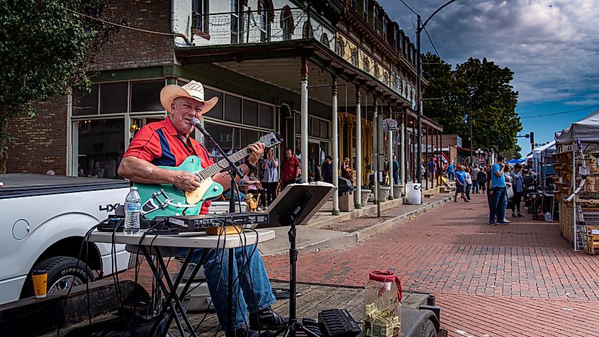 A country folk singer performs on a street stage during a fall festival in Lebanon, Illinois.