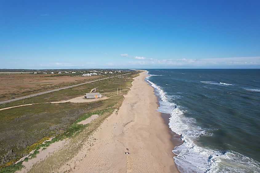 An aerial view of a long empty beach on the island of Marthas Vineyard.