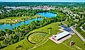 Turquoise pond water in distant summertime aerial over Mount Vernon and Ariel Foundation Park, Ohio. 