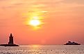 Historic Breakwater East End Lighthouse in Lewes, Delaware, at sunset