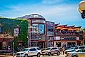 Eskimoo Joes resturant and bar under construction with people standing out front and eating on balcony near Oklahoma State University in Stillwater. Image credit Vineyard Perspective via Shutterstock