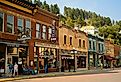 Historic saloons, bars, and shops bring visitors to Main St. in Deadwood, South Dakota. Image credit Kenneth Sponsler via Shutterstock