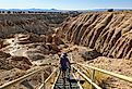 Woman hiking down a staircase into a canyon at Cathedral Gorge State Park, Panaca. Image credit nevada.claire via Shutterstock.