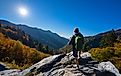 Man relaxing on an autumn hiking trip, standing on top of a mountain and enjoying the beautiful fall scenery in Smoky Mountains National Park, near Gatlinburg, Tennessee, USA