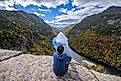 Man sitting on Indian Head Cliff at Adirondack Park, New York, USA.