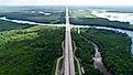 Busy highway surrounded by trees and the gorgeous, curving Sabine River. 