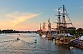 Tall ships line the river's edge at Wenonah Park in Bay City, Michigan, during the Tall Ship Celebration at sunset. Editorial credit: Craig Sterken / Shutterstock.com