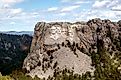 An aerial view of Mount Rushmore Narional Memorial showing the carved faces of past Presidents George Washington, Thomas Jefferson, Theodore Roosevelt, and Abraham Lincoln.