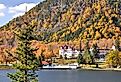 Mountainside of colorful fall foliage, Lake Gloriette, and historic Balsams Grand Resort Hotel in remote Dixville Notch, New Hampshire