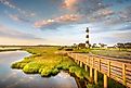 The iconic Bodie Island Lighthouse, part of Cape Hatteras National Seashore, set against the backdrop of Nags Head's coastal barrier islands in the Outer Banks, North Carolina. 