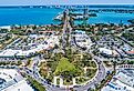 St Armands Circle in Sarasota, Florida. Drone image with sunny blue skies and crystal waters. Image credit Suncoast Aerials via Shutterstock.