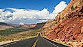 Long and scenic Bicentennial Highway (Utah State Route 95) through desert rock formations.