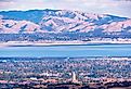 Aerial view of Palo Alto, San Francisco Bay Area; Newark and Fremont and the Diablo mountain range visible on the other side of the bay; Silicon Valley, California.