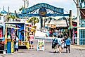 Destin, USA - April 24, 2018: Sign for Harborwalk Village in Emerald Grande Coast in Florida Panhandle with people walking and shopping,