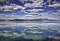 Reflections of blue skies and white puffy clouds in Walker Lake, Nebraska. 