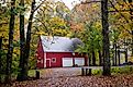 A beautiful red house is surrounded by fall colors in Manchester, Vermont. Editorial credit: Ye Choh Wah / Shutterstock.com