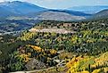 Looking out over Breckenridge, distant mountains, and changing aspen trees on a beautiful, sunny fall day in Colorado.