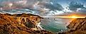 Scenic panoramic view of historic Bixby Creek Bridge along world famous Highway 1 in beautiful golden evening light at sunset with dramatic cloudscape in summer, Monterey County, California, USA