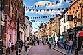 Rochester, UK: Rochester high street at weekend. People walking through the street, passing cafes, restaurants and shops