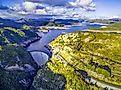 Aerial view of Gordon Dam and lake at sunset in Tasmania, Australia.