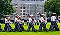 Groups of Army cadets in formation holding rifles and marching on the West Point Military Academy parade field. Editorial credit: Alan Budman / Shutterstock.com