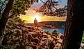 A silhouette of a man looking out into the sunset over Devils Lake State Park from a hiking viewpoint in Baraboo, Wisconsin USA.