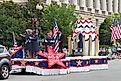 People performing atop a moving patriotic stage during the Fourth of July Parade in Washington, D.C. Editorial credit: Roberto Galan / Shutterstock.com