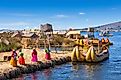 Locals welcome tourists to Uros Island on Lake Titicaca.