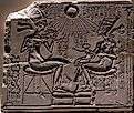 Relief depicting Akhenaten and Nefertiti with three of their daughters under the rays of Aten.