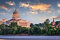 Jefferson City, Missouri, USA downtown view on the Missouri River with the State Capitol at dusk.