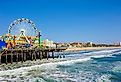 View of the Santa Monica pier in California, which features an amusement park and beach. Image credit Mark and Anna Photography via Shutterstock.