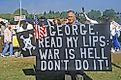 A man poses with a sign protesting the Iraq War. Editorial credit: Joseph Sohm / Shutterstock.com.