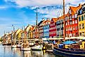 Copenhagen iconic view of the old Nyhavn port during a summer sunny day.