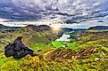 A hiker enjoying the spectacular sunset overlooking the Buttermere lake in Lake District. Cumbria. UK.