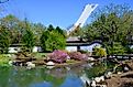 View of the tower of the Olympic Stadium rising into the sky behind the Botanical Garden in Montreal, Quebec. Editorial credit: meunierd / Shutterstock.com