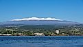 Picture of Hilo, Hawaii, on a sunny day with snow-capped Mauna Kea in the background.