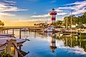 The lighthouse in Hilton Head, South Carolina, stands tall at dusk with several boats dotting the nearby waters.