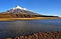 The full force of Cotopaxi, an active stratovolcano in Ecuador, with Laguna de Limpiopungo in the foreground.