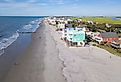 Aerial view of homes along the sandy beach in Folly Beach, South Carolina.