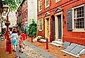 A family strolls down Elfreth's Alley, Philadelphia, the oldest street in continuous use in the United States.