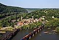 A train rolls across the Shenandoah River in an aerial view of the town of Harpers Ferry, West Virginia, which includes Harpers Ferry National Historical Park.