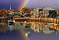 Fishing boat harbor at Rockport with rainbow in the background. Image credit Bob Pool via Shutterstock.