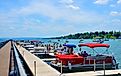 Pier and luxury boats docked in the Skaneateles Lake. Editorial credit: PQK / Shutterstock.com